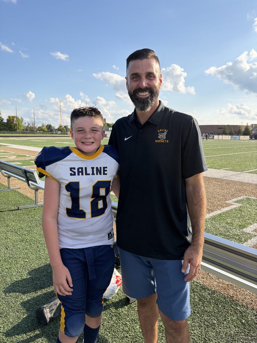 Matt Shoemaker with his son on the Saline Hornets football field
